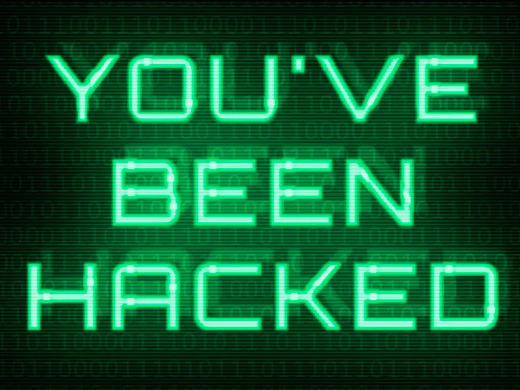 Glowing green text on a black background displays the message "YOU'VE BEEN HACKED" in a digital, pixelated font.