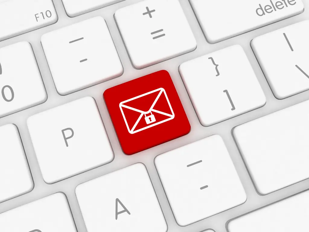 A close-up of a computer keyboard with a red key featuring a white envelope and lock symbol, suggesting secure email or encrypted messaging.