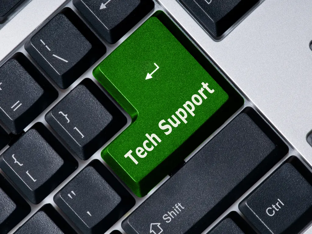 A close-up of a computer keyboard with a green "Tech Support" key replacing the usual Enter key.